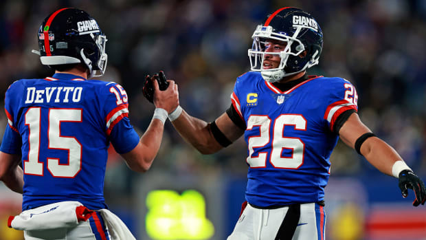 Tommy DeVito celebrates a touchdown with Saquon Barkley.